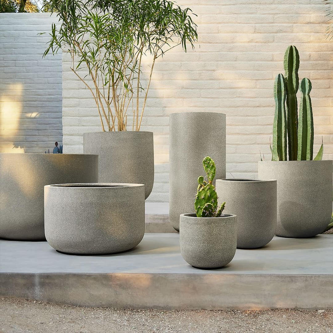 Grey engineered stone planters in round bowl and tall cylinder shapes