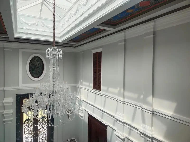 Double-height hall with skylight mouldings and wall cornices