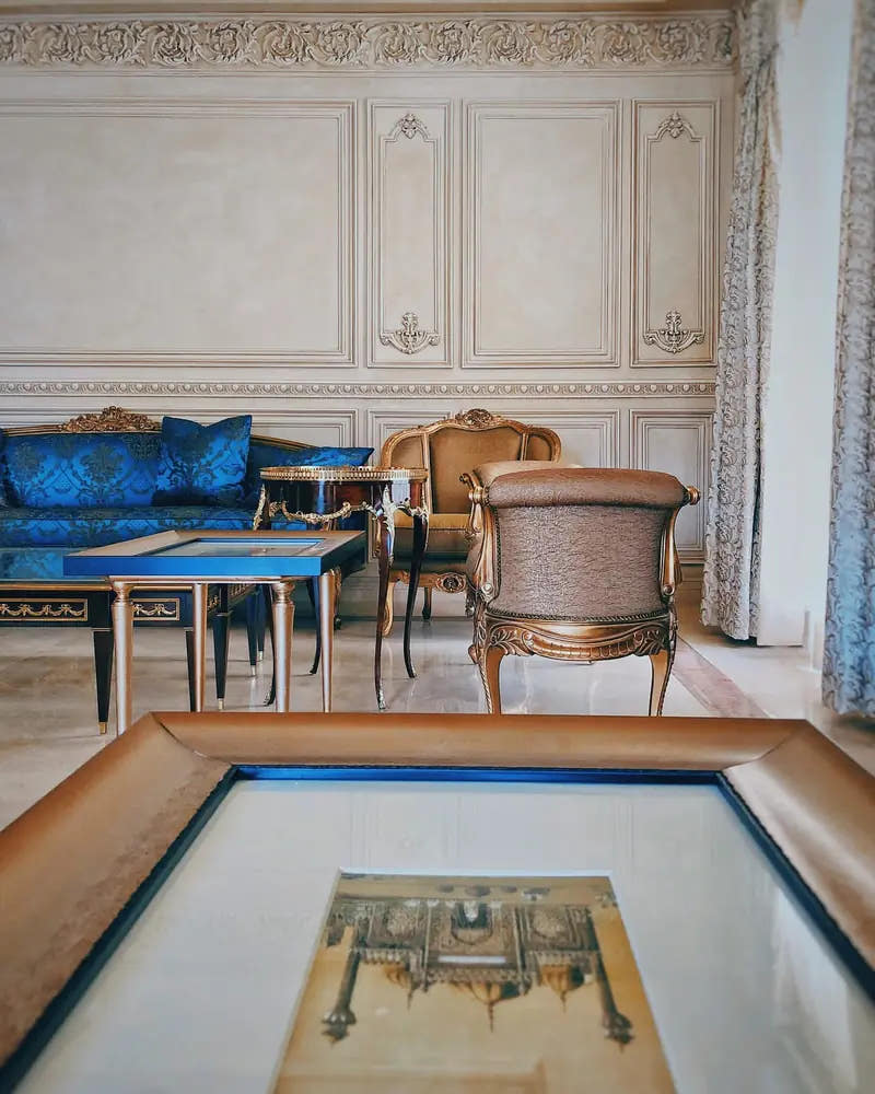 Living room with wall panel mouldings and carved frieze