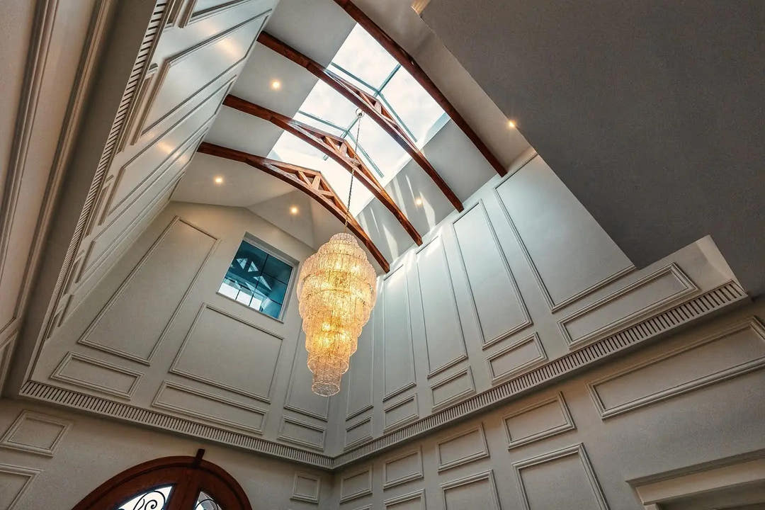 Skylight with timber trusses, wall panel mouldings and chandelier