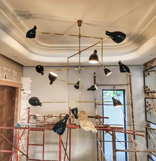Modern chandelier under a layered ceiling