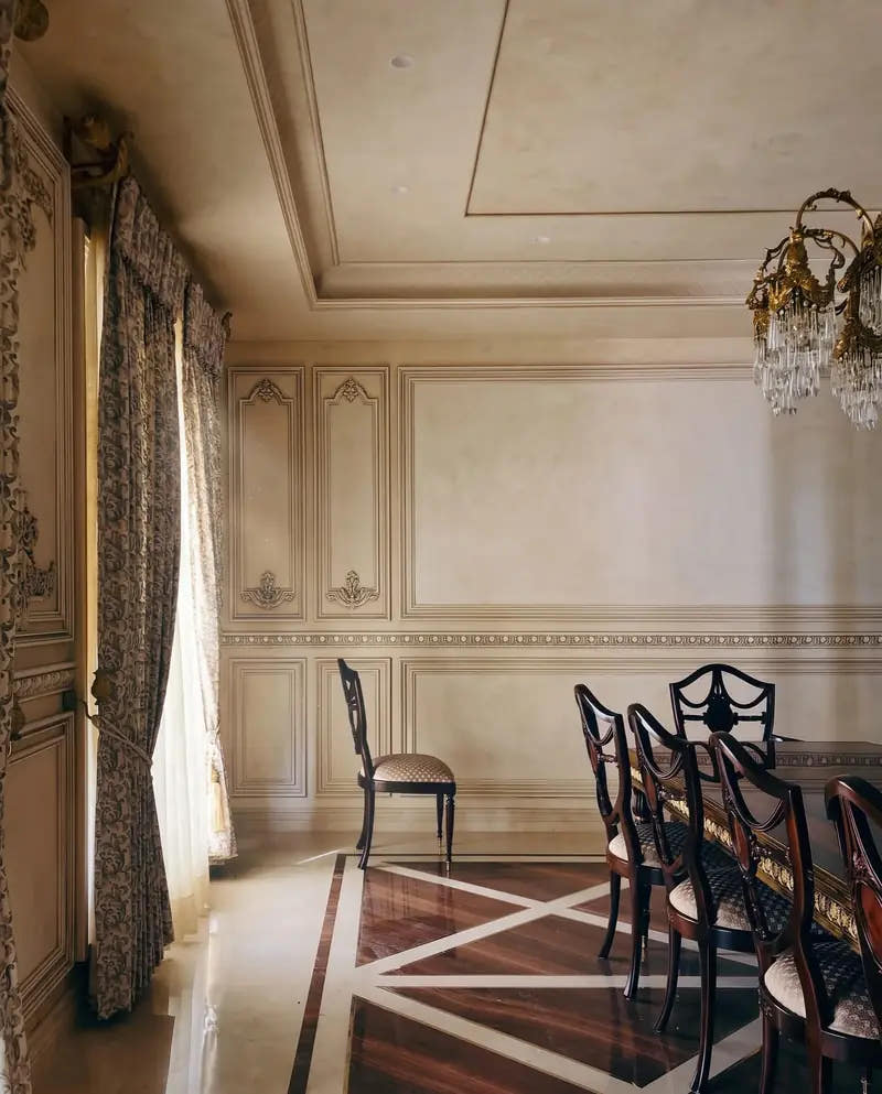 Dining room with wall panel mouldings and layered ceiling cornice