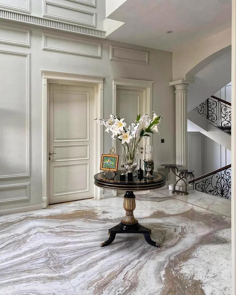Foyer with wall panel mouldings, door surrounds and fluted column