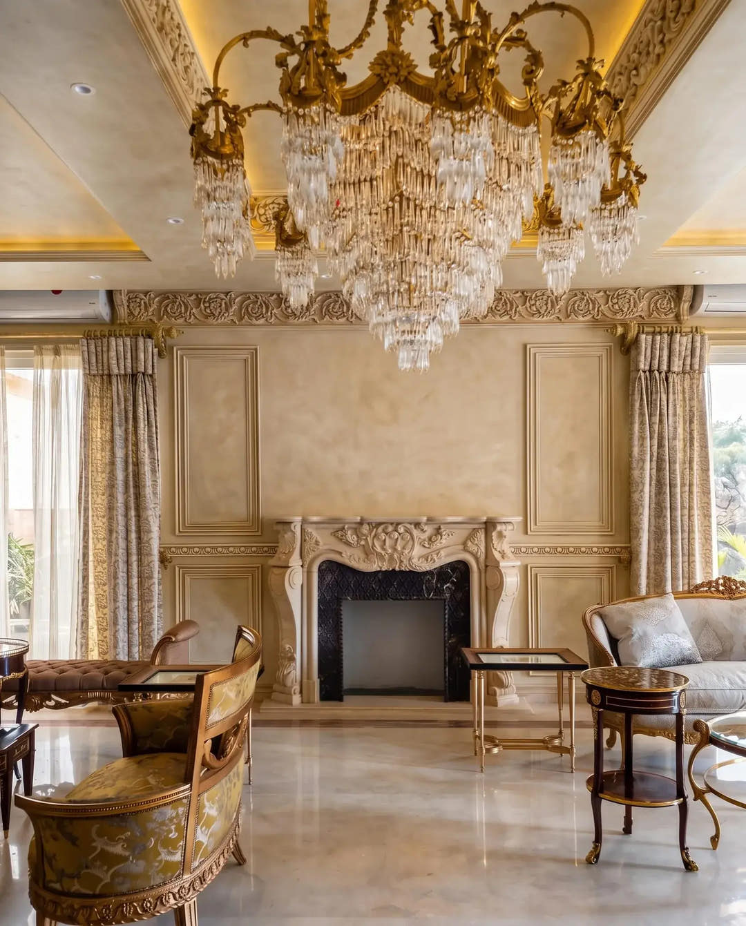 Formal living room with carved frieze, wall mouldings and gilded chandelier