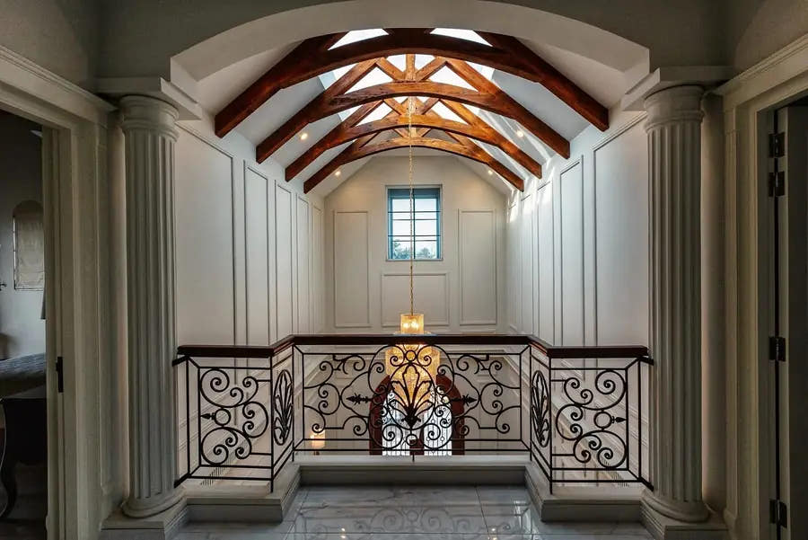 Upper gallery with columns, wall panels and timber trusses